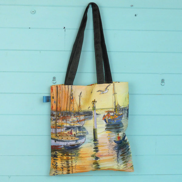 a tote bag printed with old gaffers sailing boats at sunset at Yarmouth on the isle of wight